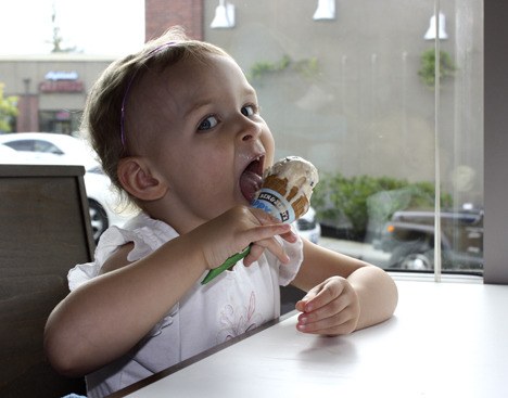 Bella Douglas is too busy enjoying ice cream to notice it dripping down the cone.
