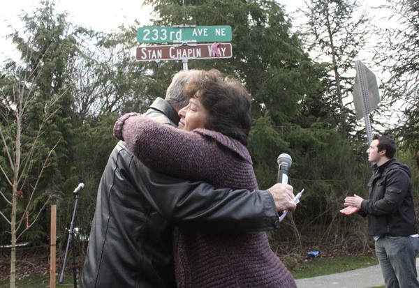 Sue Chapin hugs Sammamish Mayor Tom Odell after unveiling the new sign dedicated to her husband Stan