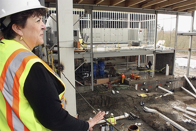 Sammamish Parks and Recreation Project Manager Sevda Baran looks on as construction crews assemble the piping for the future leisure pool