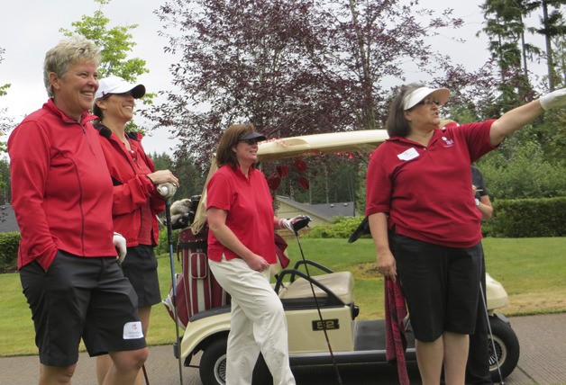Molly Miller (far left) shares a laugh with a group during Golf Fore Red at Redmond Ridge.