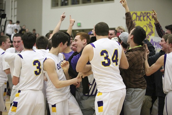 Issaquah fans rush the court to celebrate with players after the Eagles beat rival Skyline 59-56 on Tuesday night.