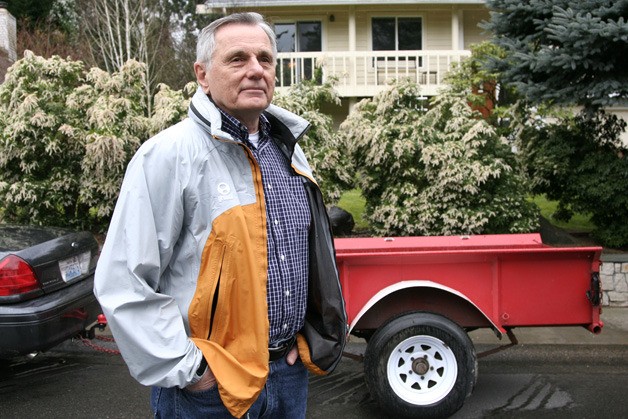 Dick Buckwitz stands in front of a trailer he uses to haul his own compost. Unlike the rest of the city