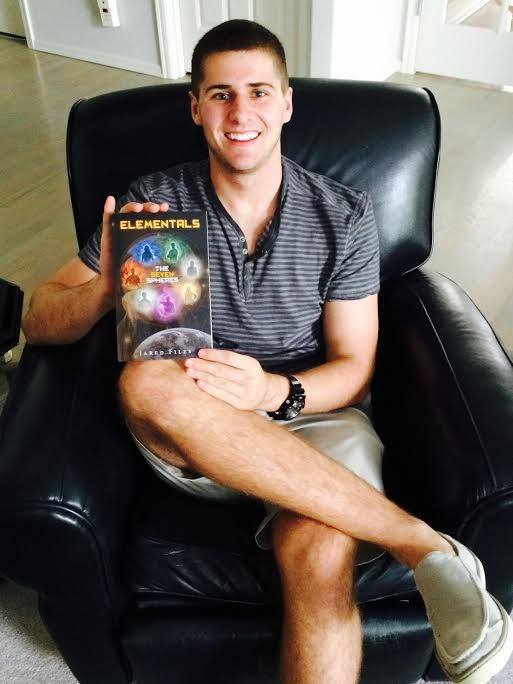 Eastlake High School graduate Jared Files poses with his newly published book 'Elementals: The Seven Spheres.'