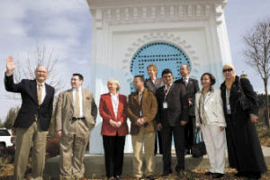 Members of the Moroccan delegation and the Issaquah City Council stand in front of the blue door during the dedication ceremony.