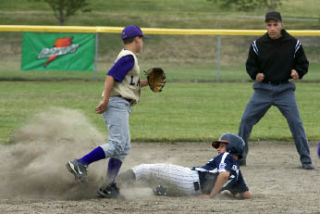 Eastlake Little Leaguer Ryan Cornwall slides safely into second base Tuesday night in Auburn.