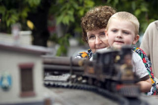 3-year-old J.J. Sawyer gets a lift from his Grandmother Cindy Bjorkman so he could get a better look at one of the scale models on display at the Issaquah Train Depot.