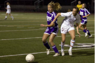 Issaquah’s Margaret Rauch and Eastlake’s Kory Spotts battle for a loose ball Tuesday night.
