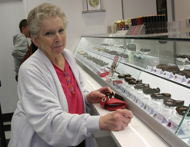 Ann Newton samples her favorite See’s Candies chocolate in Issaquah. The candy chain opened a traditional-styled store in the Issaquah Commons on Jan. 20
