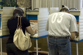 Issaquah residents Jenny and Kenneth Fullwood make their voices heard as they cast their votes at the polls at Issaquah Community Church Monday evening.