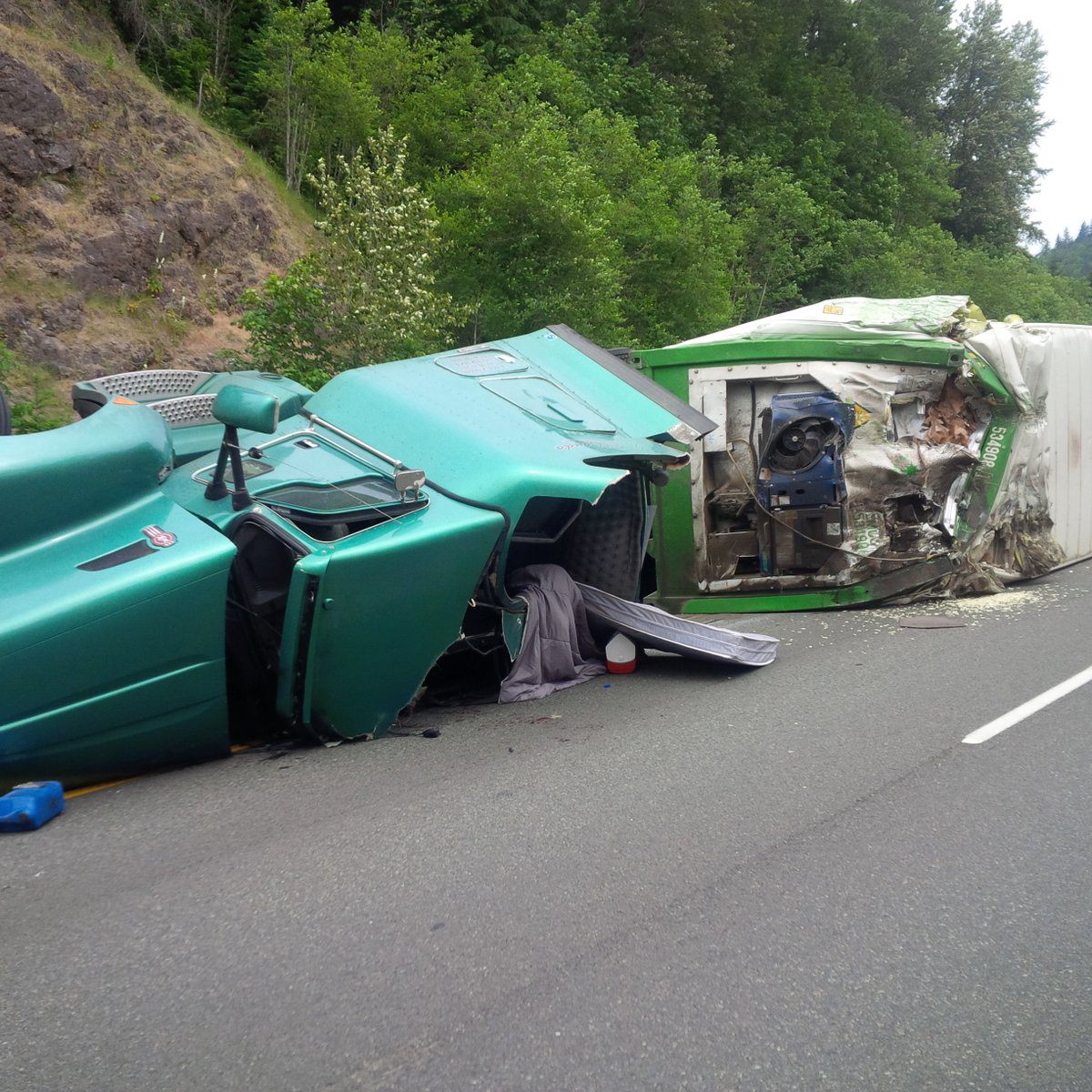 A semitrailer towing a trailer flipped onto its side just on State Route 18 in a three-car accident east of Issaquah-Hobart Road on Wednesday. Photo courtesy of Chris Webb/Twitter