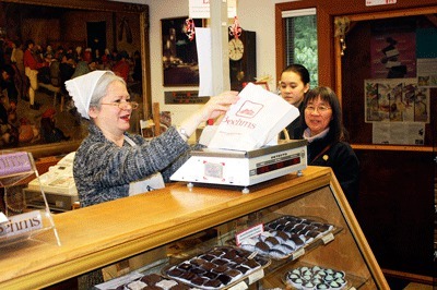 Boehm's front counter sales clerk Mindy Reid rings up a sale of chocolate pieces for Sammamish residents Marlene Wissler and her daughter