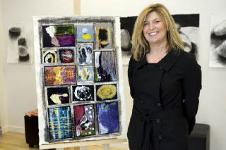 Marci Knutsen of Museo stands next to a work prepared by students and instructors for an auction tonight. See story