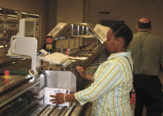 Laquita Crumwell sorts incoming ballots from the May 20 election at the King County Elections Building last week.
