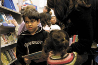 Above: 5-year-old Ethan Naziri reacts disagreeably to a book title as he negotiates with his mother Elizabeth for new books at Discovery Elementary School. Right: Erin Sebo’s daughter Miller