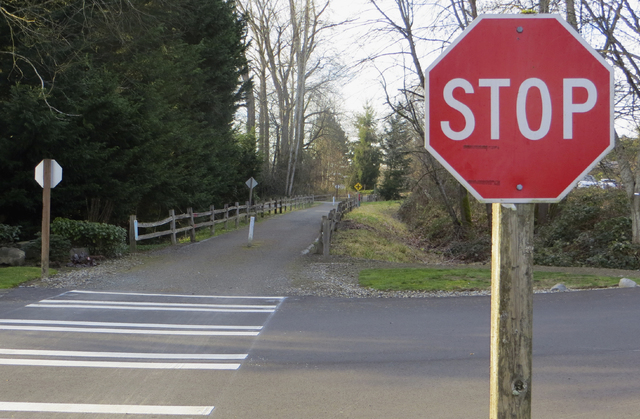 The southern segment of the East Lake Sammamish Trail at 206th Avenue Southeast before construction began. Here the county wants to relocate these stop signs so trail users can have the right of way. Megan Campbell/staff photo