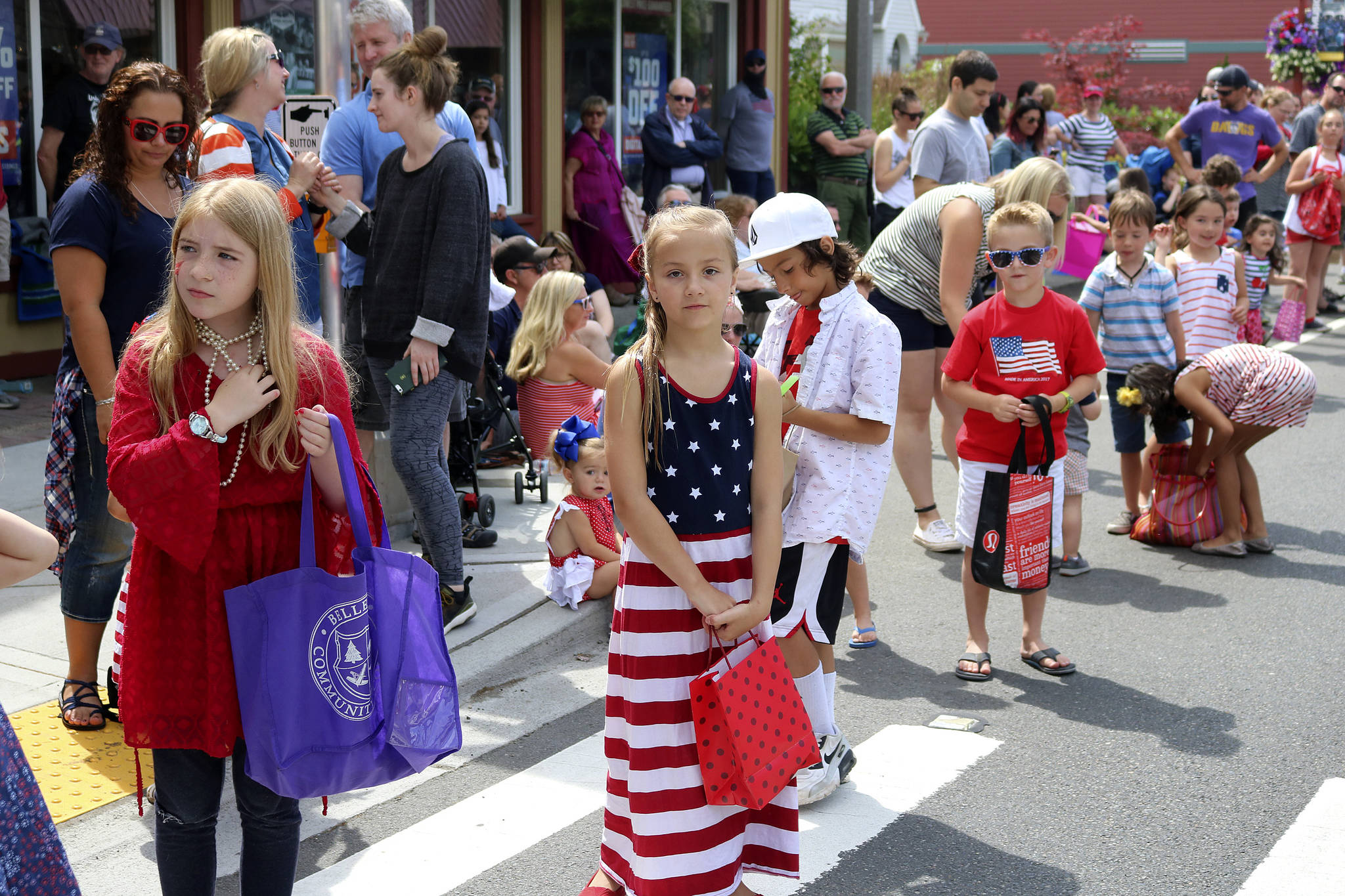 Kids lined up along the parade route to catch Tootsie Rolls and Snickers. Nicole Jennings/staff photo