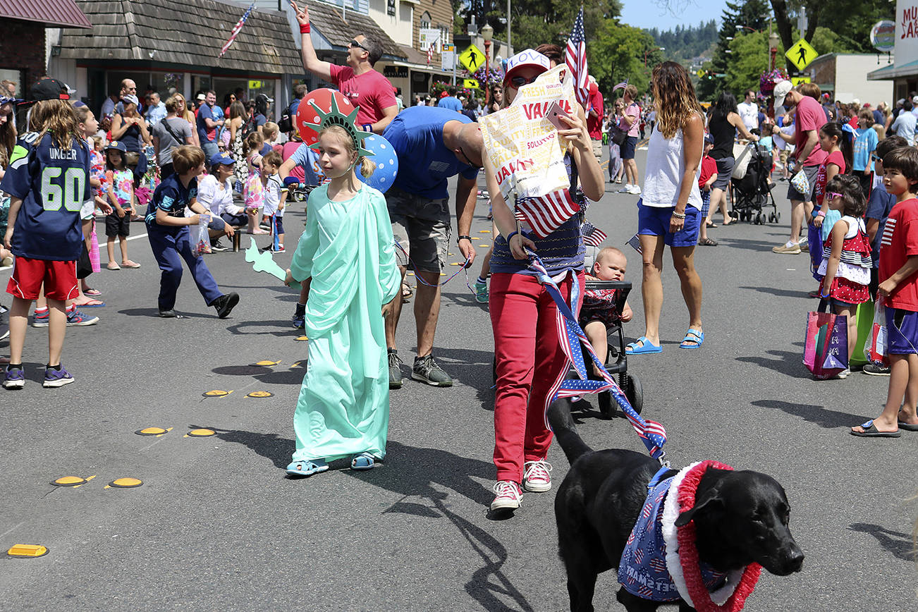 Lady Liberty waved to her fellow Americans as she strolled down Front Street with her equally patriotic pup. Nicole Jennings/staff photo