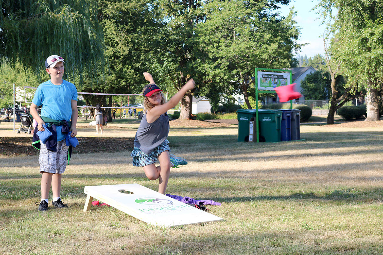 Quinn and Bryce Corbett play beanbag golf as soon as they arrived at the park. (Evan Pappas/Staff Photo)