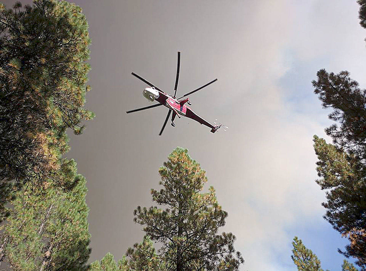A fire helicopter fights the Jolly Mountain Fire on Saturday. Photo courtesy of Harvey Moyer