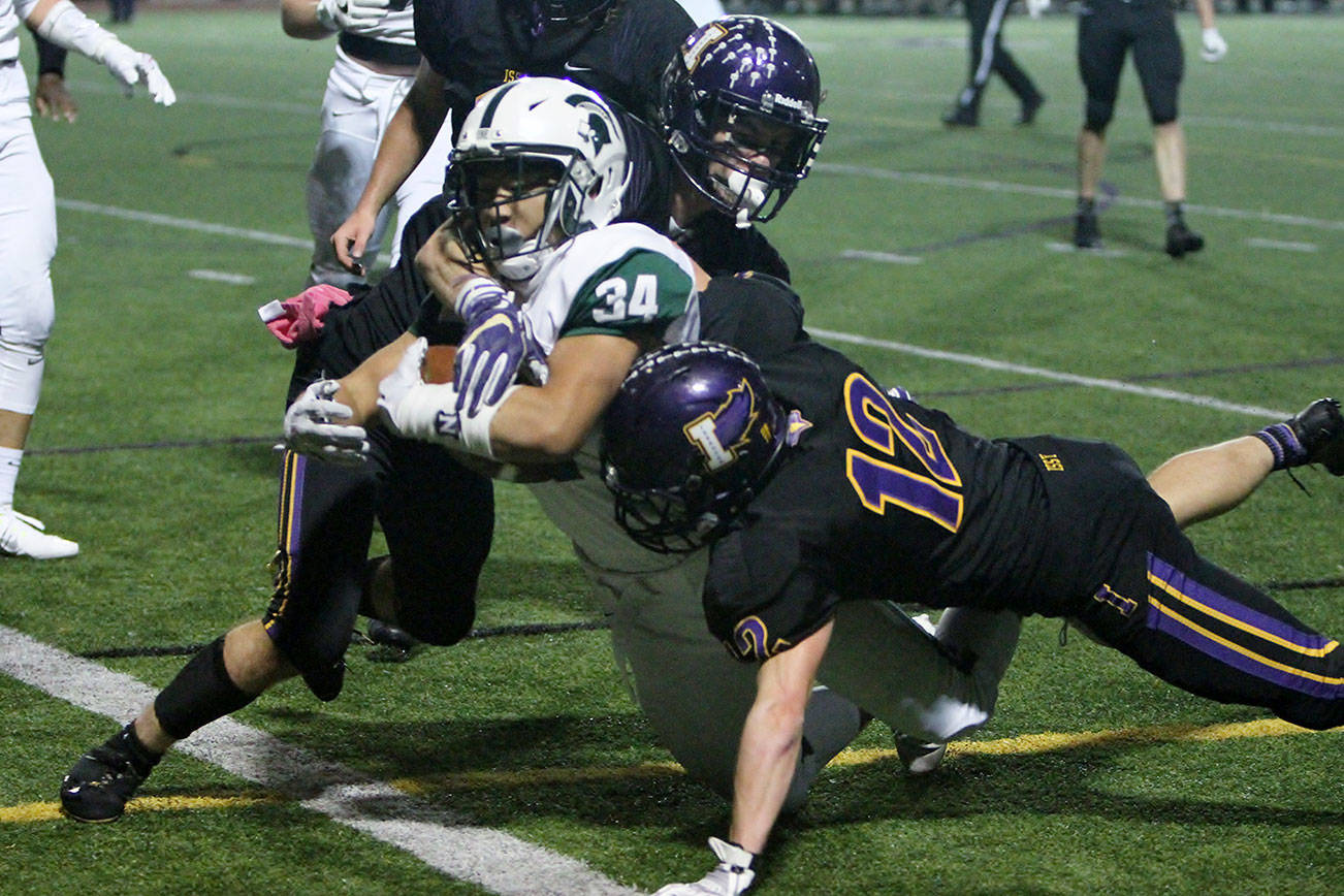 Photo courtesy of Jim Nicholson                                The Skyline Spartans registered a 42-28 win against the Issaquah Eagles in the regular season finale on Oct. 27 at Gary Moore Stadium in Issaquah. Spartans’ running back Prescott Wong (pictured) plows forward for yardage against the Eagles defense. Skyline (6-3) will face the Enumclaw Hornets in a winner-to-state, loser-out district playoff game on Nov. 3.