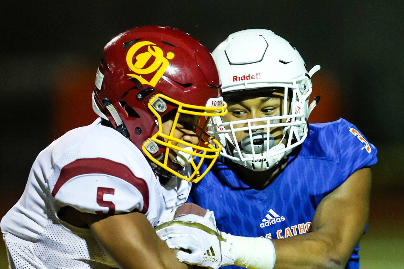 Photo courtesy of Rick Edelman/Rick Edelman Photography                                Eastside Catholic Crusaders safety Malik Putney, right, makes a tackle against the O’Dea Fighting Irish in a contest earlier this season.