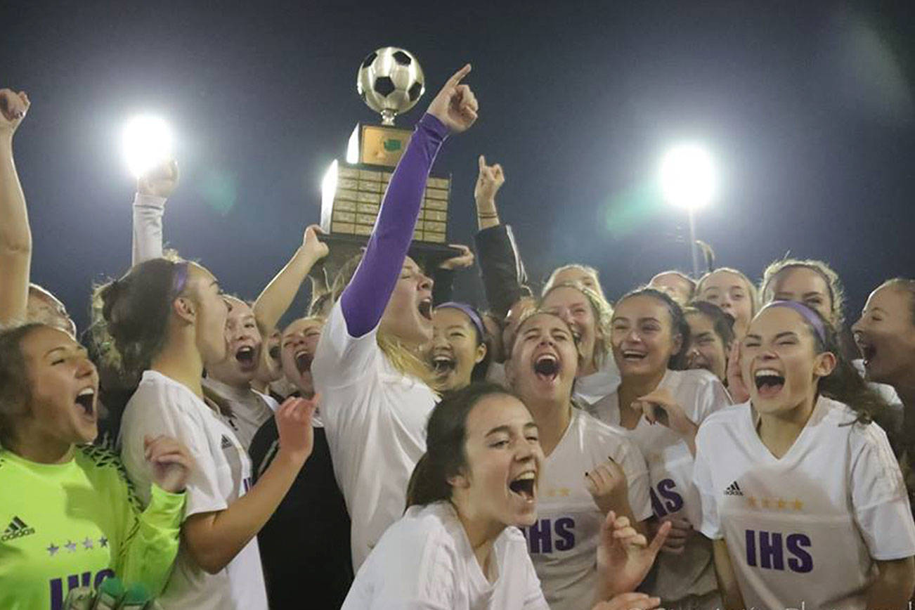 Photo courtesy of Don Borin/Stop Action Photography                                The Issaquah Eagles girls soccer team hoists the championship trophy following their 2-1 victory against the Central Valley Bears in the Class 4A girls soccer state title game on Nov. 18 at Sparks Stadium in Puyallup.
