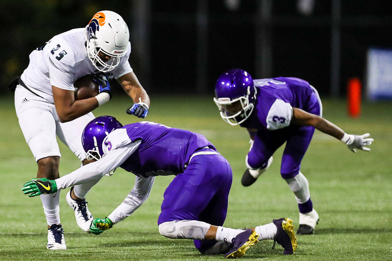 Photo courtesy of Rick Edelman/Rick Edelman Photography                                The Garfield Bulldogs defeated the Eastside Catholic Crusaders 13-10 in double overtime in a Class 3A football quarterfinal matchup on Nov. 17 at Memorial Stadium in Seattle. The Crusaders finished the 2017 season with an overall record of 10-1. Eastside Catholic sophomore tight end DJ Rogers, left, gets tackled by Garfield defensive back Tre’Shaun Harrison, right, during the game on Nov. 17.