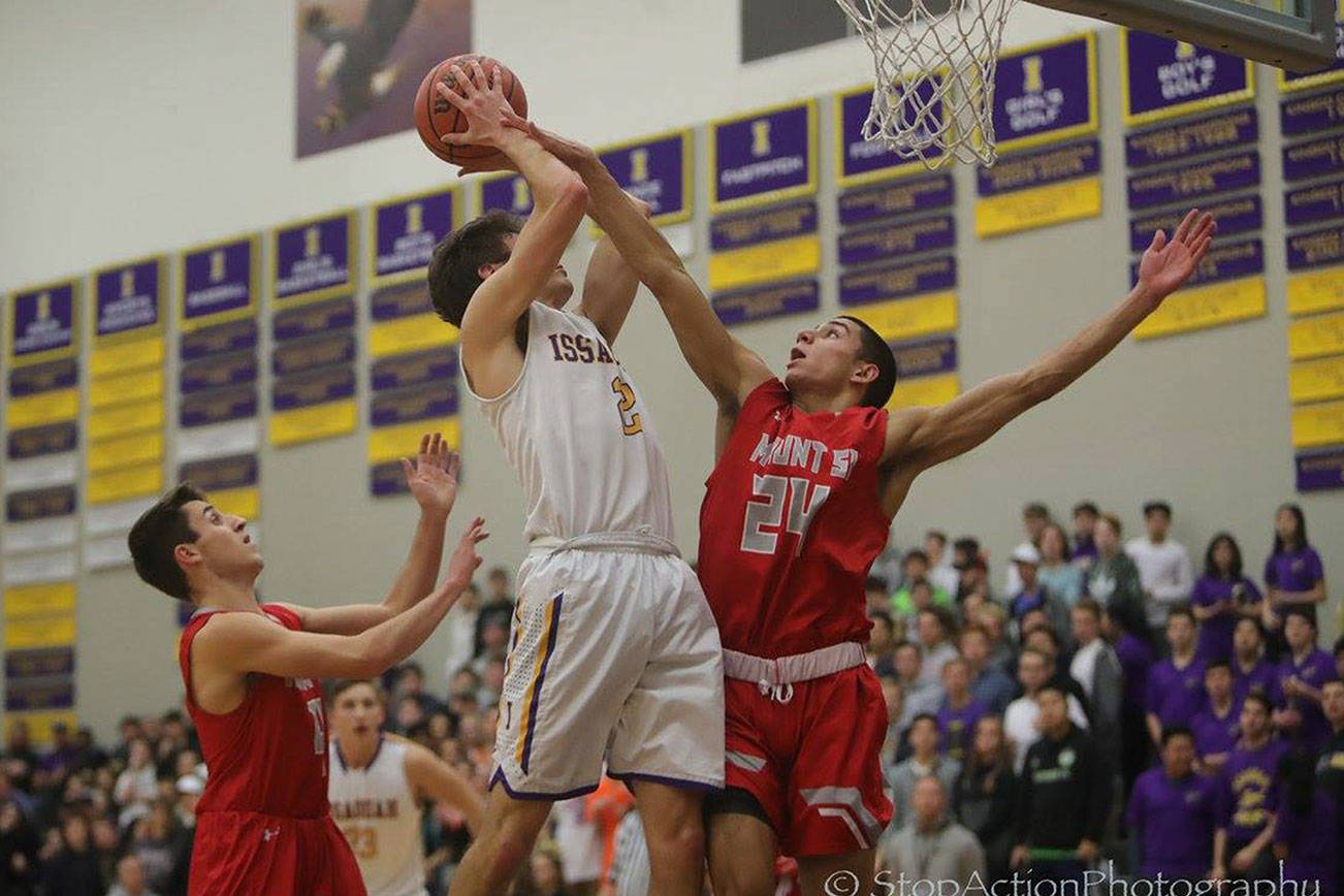 Photo courtesy of Don Borin/Stop Action Photography                                The Issaquah Eagles boys basketball team earned a 68-64 victory against the Mount Si Wildcats on Jan. 5. Issaquah improved its overall record to 4-6 with the win. Issaquah senior forward Will Farmer, left, takes the ball strong to the hoop against Mount Si junior guard Bijon Sidhu.