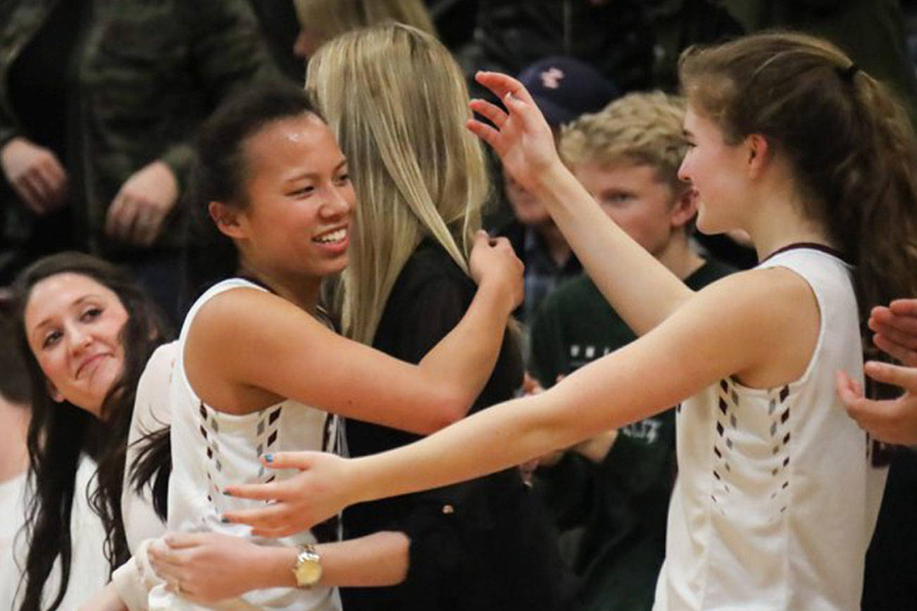 Photo courtesy of Don Borin/Stop Action Photography                                Eastlake Wolves senior point guard Gina Marxen embraces coaches and teammates after on senior night in the regular season finale against the Issaquah Eagles on Feb. 6.