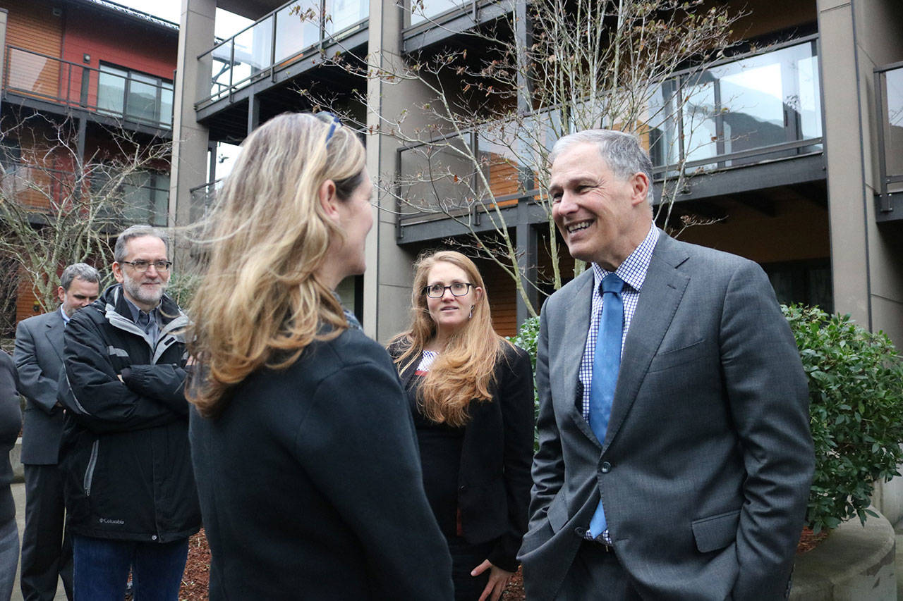 Gov. Inslee greets new Issaquah Mayor Mary Lou Pauly outside the zHome housing development, the first zero net energy townhouse development in the United States. Nicole Jennings/staff photo