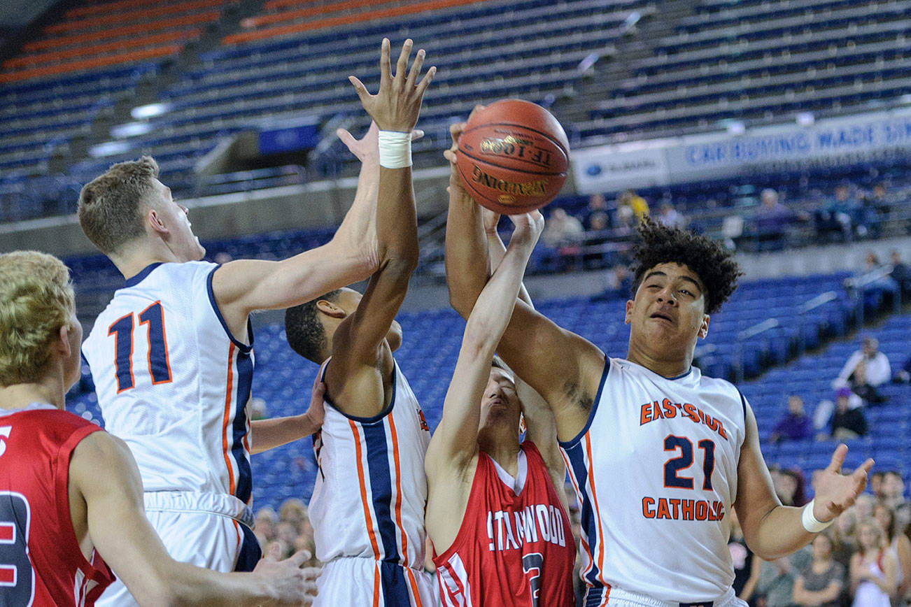 Photo courtesy of Patrick Krohn/Washington Prep Athletics Network                                Eastside Catholic Crusaders freshman Jaylahn Tuimoloau, right, pulls down a rebound in the first round of the Class 3A state playoffs on Feb. 28 at the Tacoma Dome.