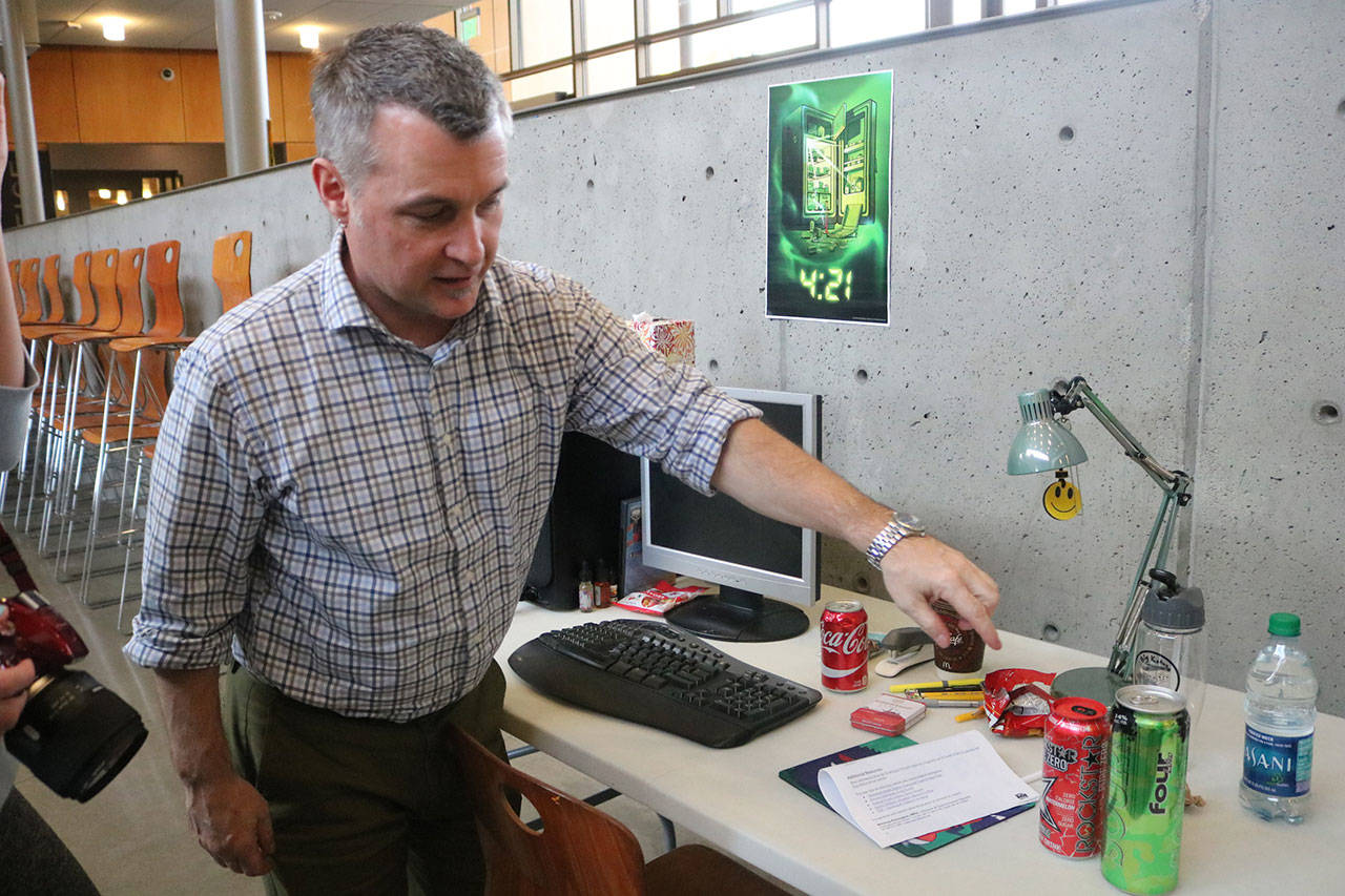 Issaquah Friends of Youth Director Jerry Blackburn shows how some alcohols are designed to look like energy drinks.