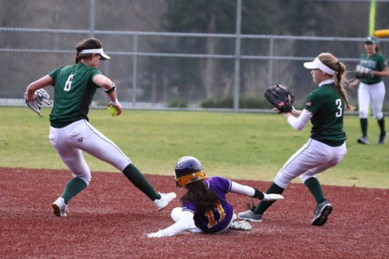 Photo courtesy of Don Borin/Stop Action Photography                                Skyline Spartans shortstop Taylor Juenke, left, hustles to tag second base while Issaquah sophomore Kendal Gentzen slides into second base in a contest between KingCo 4A rivals on March 30 at Issaquah High School.