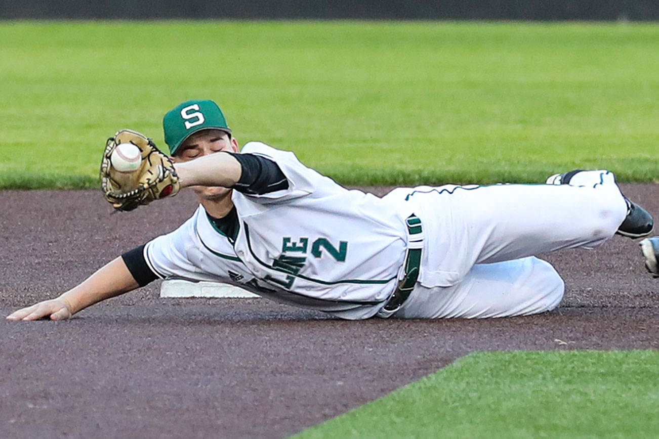 Photo courtesy of Rick Edelman/Rick Edelman Photography                                Skyline Spartans shortstop Alex Brenner, left, dives for a ball while Inglemoor baserunner Eunsang Yu slides into second base in the KingCo 4A baseball championship game on May 9 at Bannerwood Park in Bellevue. Inglemoor defeated Skyline 7-3.