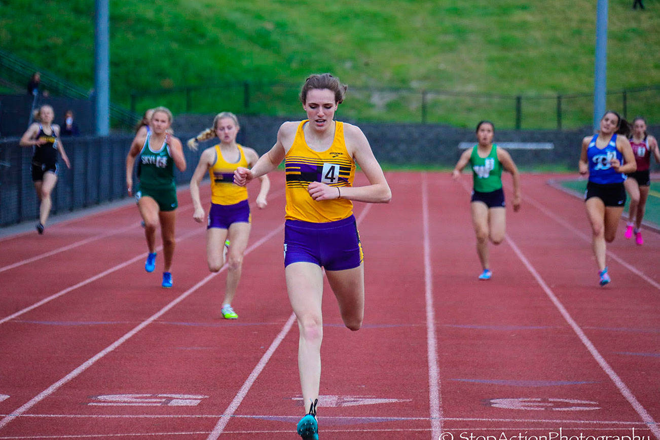 Photo courtesy of Don Borin/Stop Action Photography                                Issaquah Eagles senior Elise Burdette, center, registered a first place finish in the 400 with a time of 56.95 at the Class 4A District II track championships on May 18 at the Southwest Athletic Complex in Seattle.