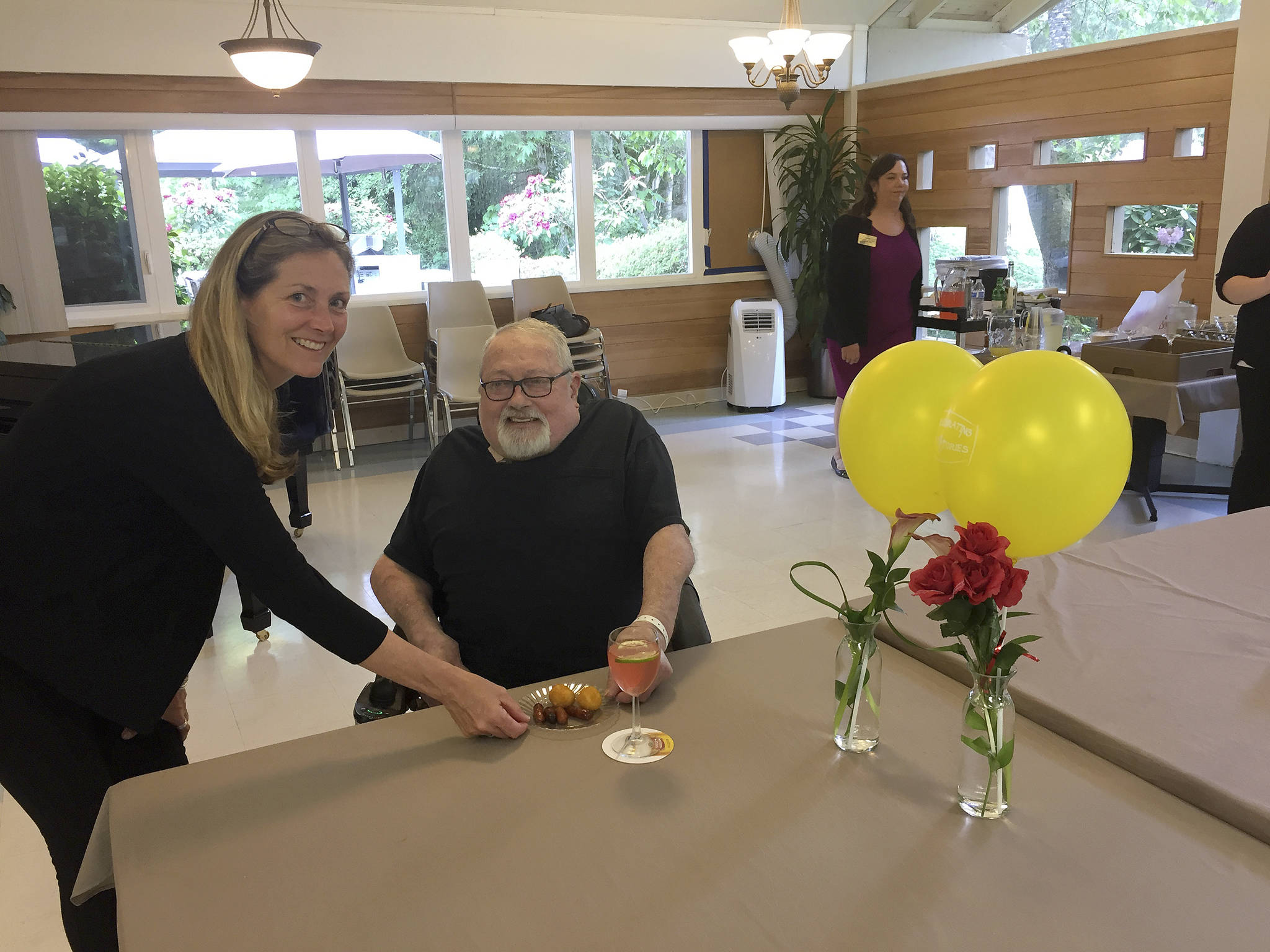 Issaquah Mayor Mary Lou Pauly serves hors d’oeuvres to resident Russell Waterhouse of Renton at Issaquah Nursing & Rehabilitation during a “Martinis with the Mayor” event last week. William Shaw/staff photo