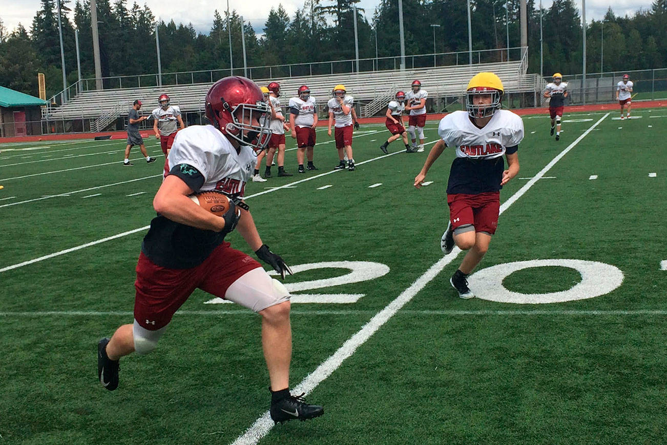 Eastlake Wolves senior Broc Stauffer hauls in a short pass before turning the ball upfield during a spring football practice session on June 5 in Sammamish.                                Shaun Scott, staff photo