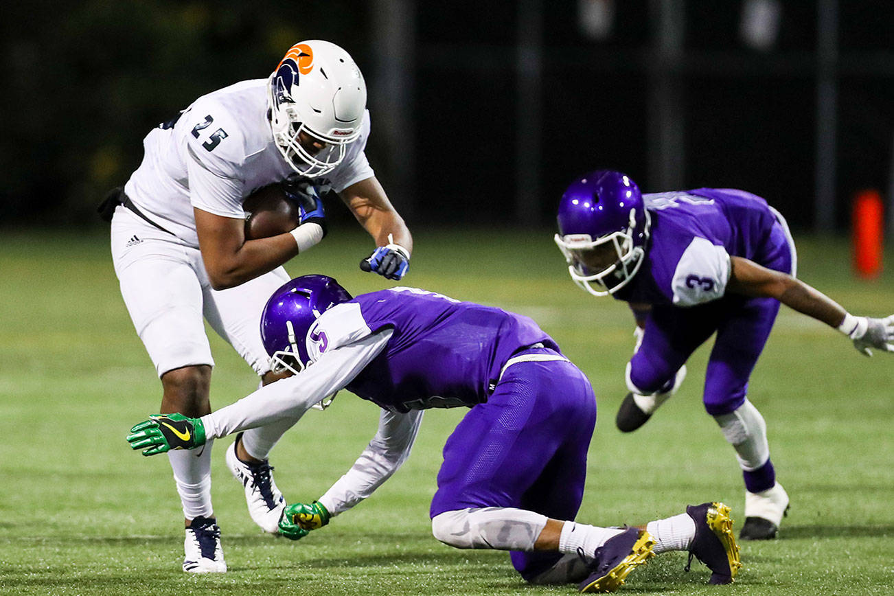 Eastside Catholic Crusaders tight end DJ Rogers, left, gets tackled against the Garfield Bulldogs in the Class 3A state quarterfinals on Nov. 17, 2017. The Crusaders finished the 2017 season with an overall record of 10-1. Photo courtesy of Rick Edelman/Rick Edelman Photography