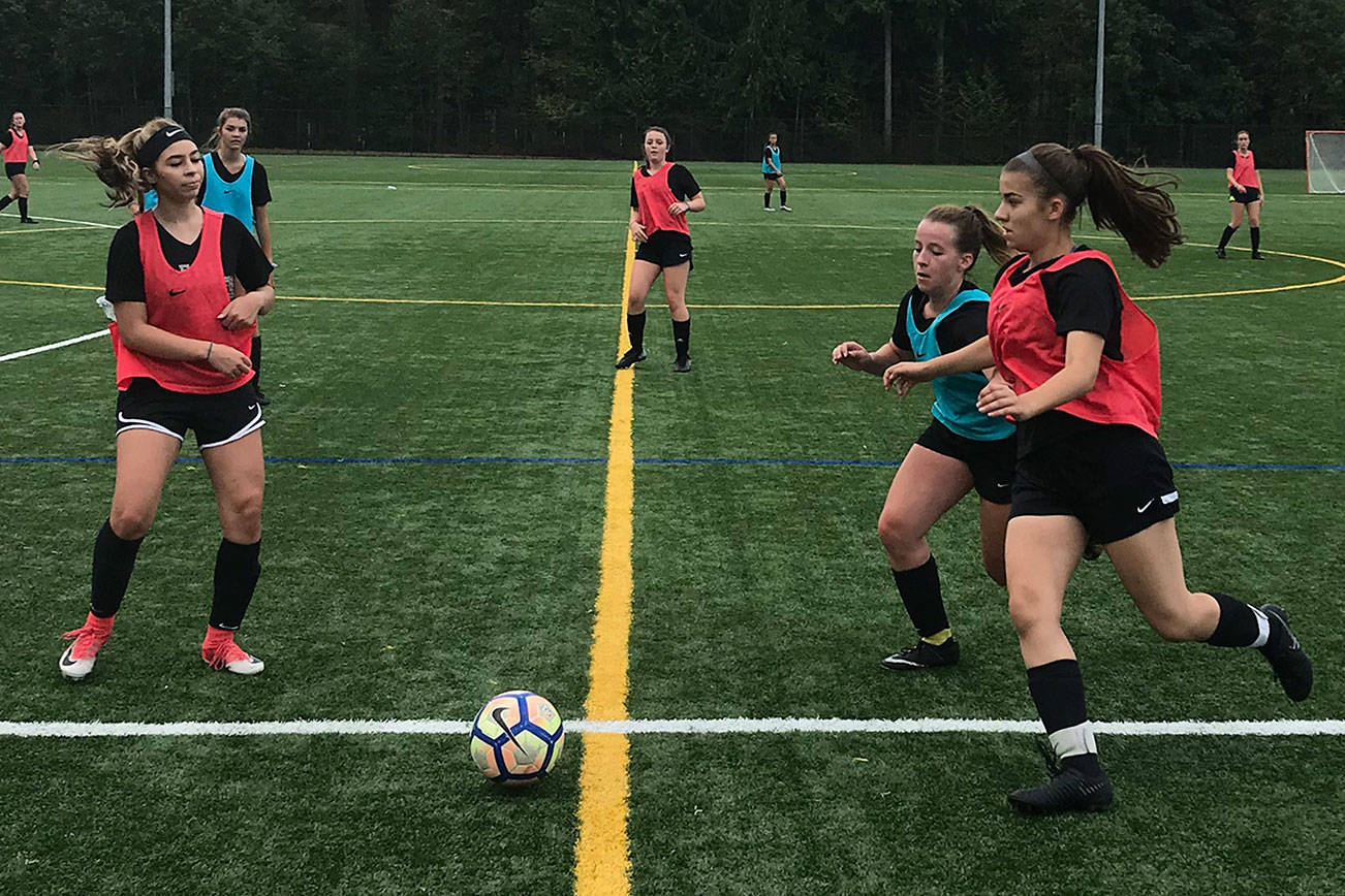The Eastlake Wolves girls soccer team conducts a Monday morning practice sessions on Aug. 27 in Sammamish. Shaun Scott/staff photo