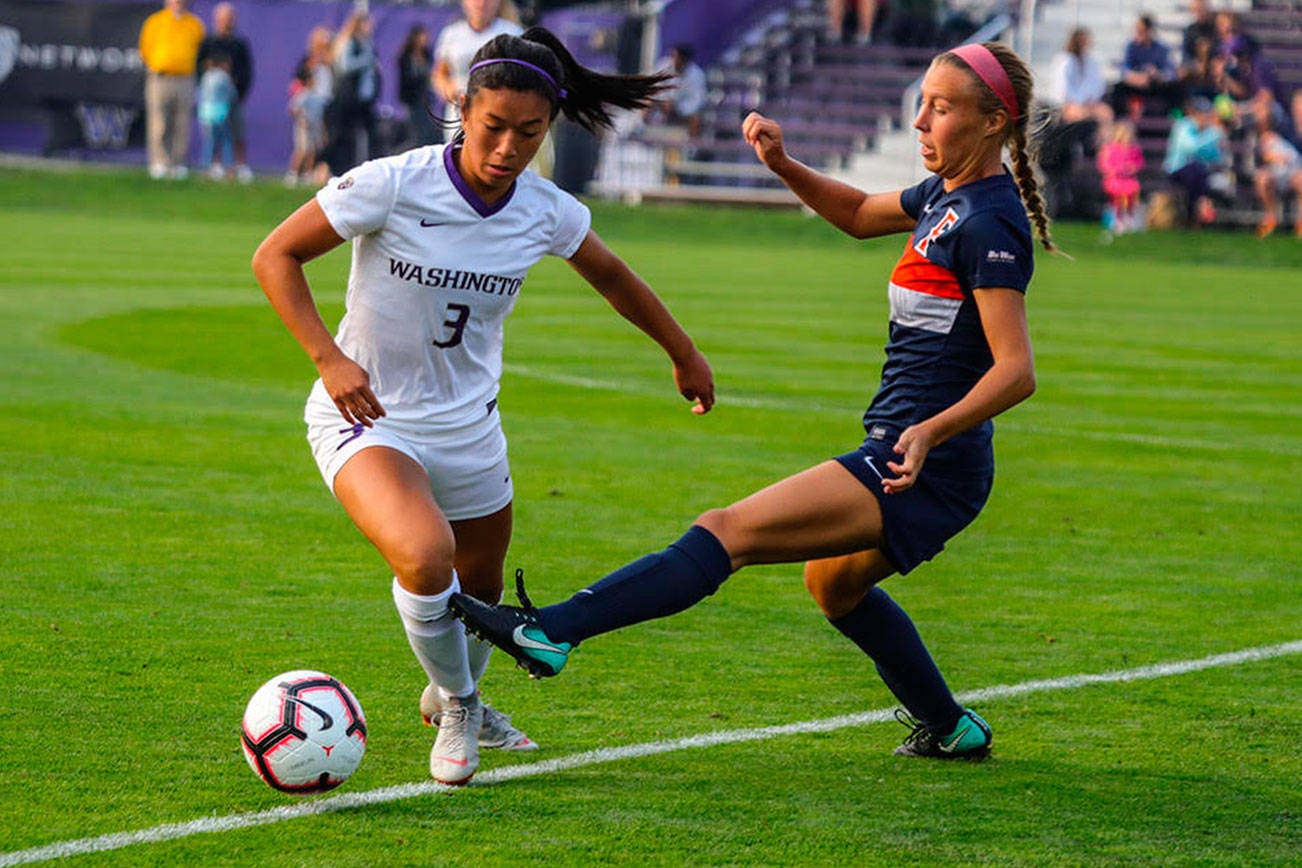 Issaquah Eagles 2017 graduate Kaylene Pang, left, controls the ball during a game against Cal State Fullerton on Aug. 24 in Seattle. The Huskies defeated Cal State Fullerton, 3-0. Pang, who is a sophomore defender with the University of Washington Huskies women’s soccer program, made 10 appearances during her freshman season in 2017. Photo courtesy of Don Borin/Stop Action Photography