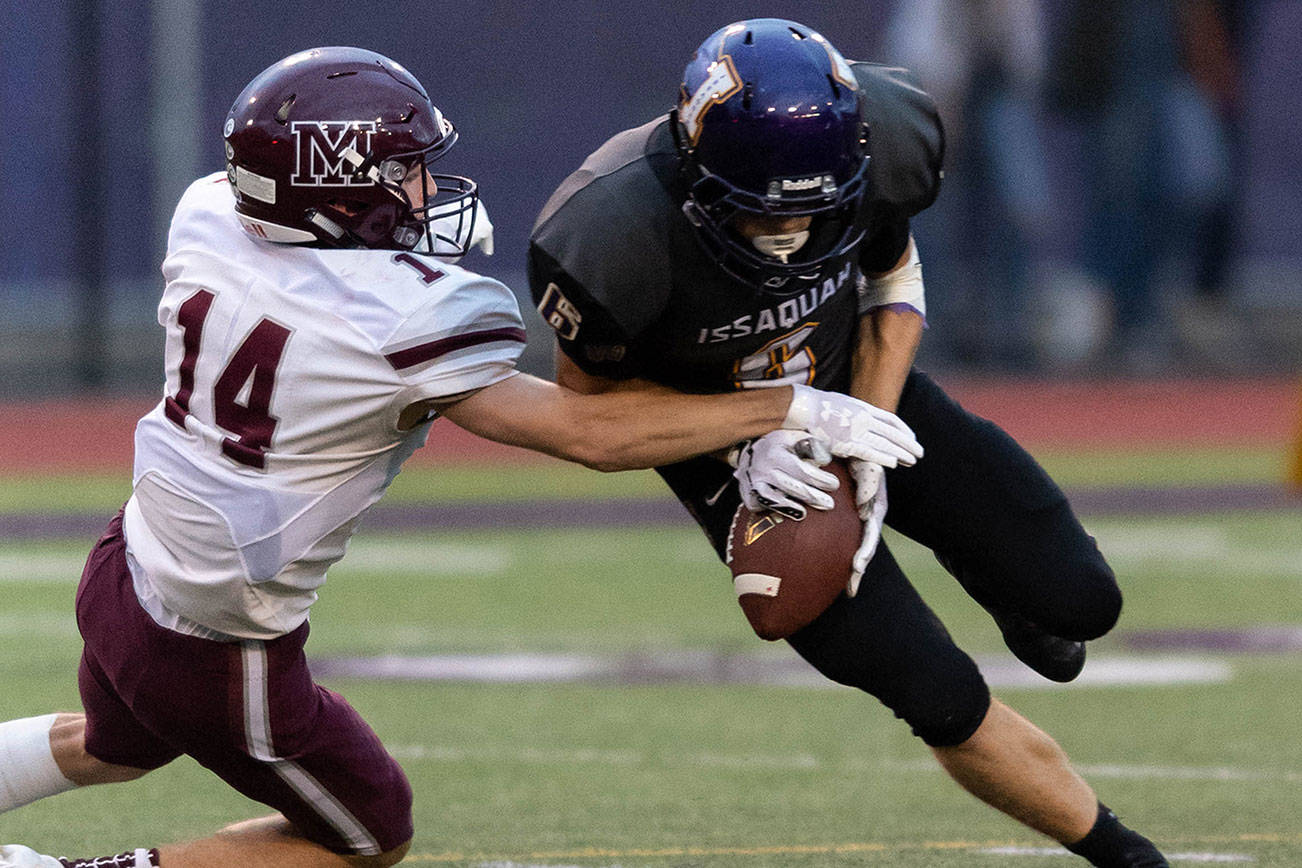 Issaquah Eagles senior wide receiver Lucas Senatore, right, holds on to the ball while Mercer Island defensive back Hunter Johnson, left, tries to dislodge the ball. Photo courtesy of Patrick Krohn/Patrick Krohn Photography
