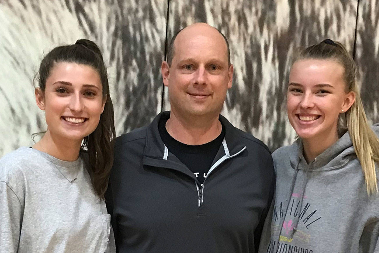 The Eastlake Wolves volleyball team is led by senior outside hitter Lauren Martin, left, and junior outside hitter Anna Ilstrup, right. Former Eastlake assistant coach Mike Knapick (center) is in his first season leading the Wolves varsity program. Shaun Scott/staff photo
