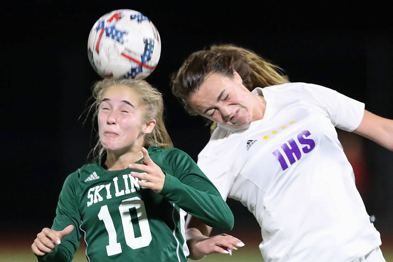 The Issaquah Eagles earned a 1-0 victory against the Skyline Spartans in a 4A KingCo soccer contest between rivals on Sept. 22. Issaquah improved its overall record to 4-0-1 with the victory. Skyline dropped to 3-4-1 with the loss. Skyline sophomore Brooke Mayes, left, and Issaquah defender Riley Larson, right, battle for possession of a 50/50 ball during the game. Photo courtesy of Rick Edelman/Rick Edelman Photography