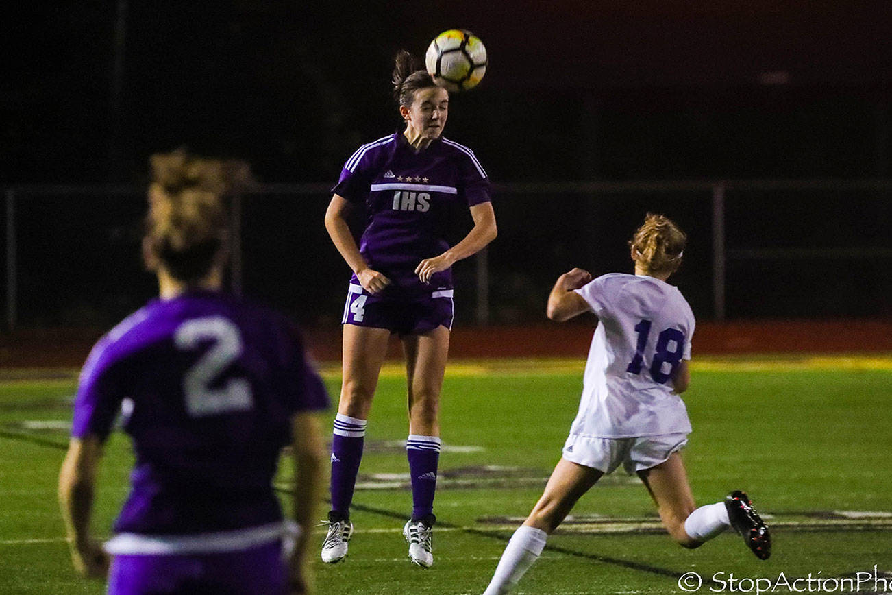 Issaquah Eagles senior defender Kate Wilkinson connects on a header in a game earlier this season. Wilkinson has led the Eagles to a 5-0-1 record in early season action. Photo courtesy of Don Borin/Stop Action Photography