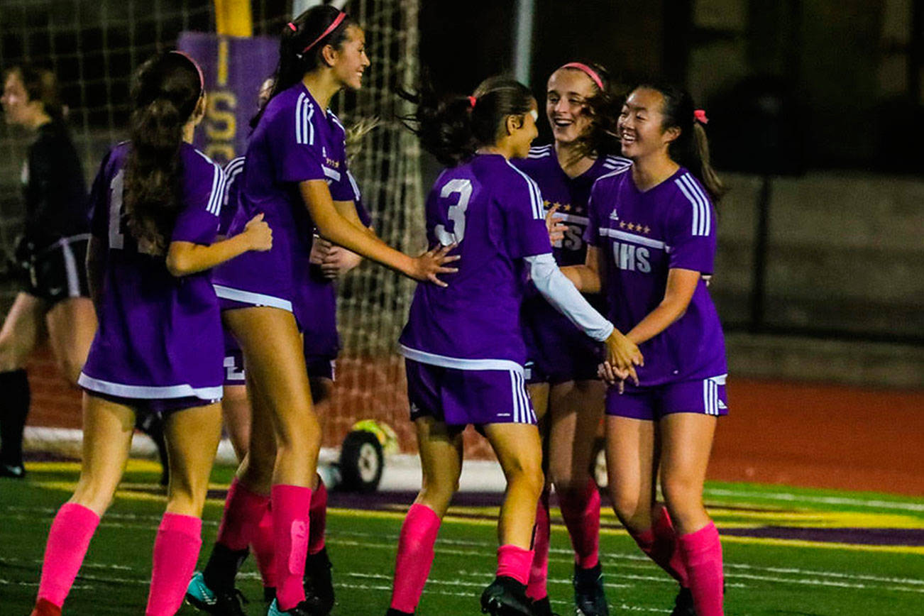 Issaquah players mob Sarah Kim, right, after she scored a goal in the 52nd minute, giving Issaquah a 2-1 lead against the Eastlake Wolves. Issaquah earned a 3-1 win against Eastlake on Oct. 11 at Gary Moore Stadium in Issaquah. Photo courtesy of Don Borin/Stop Action Photography