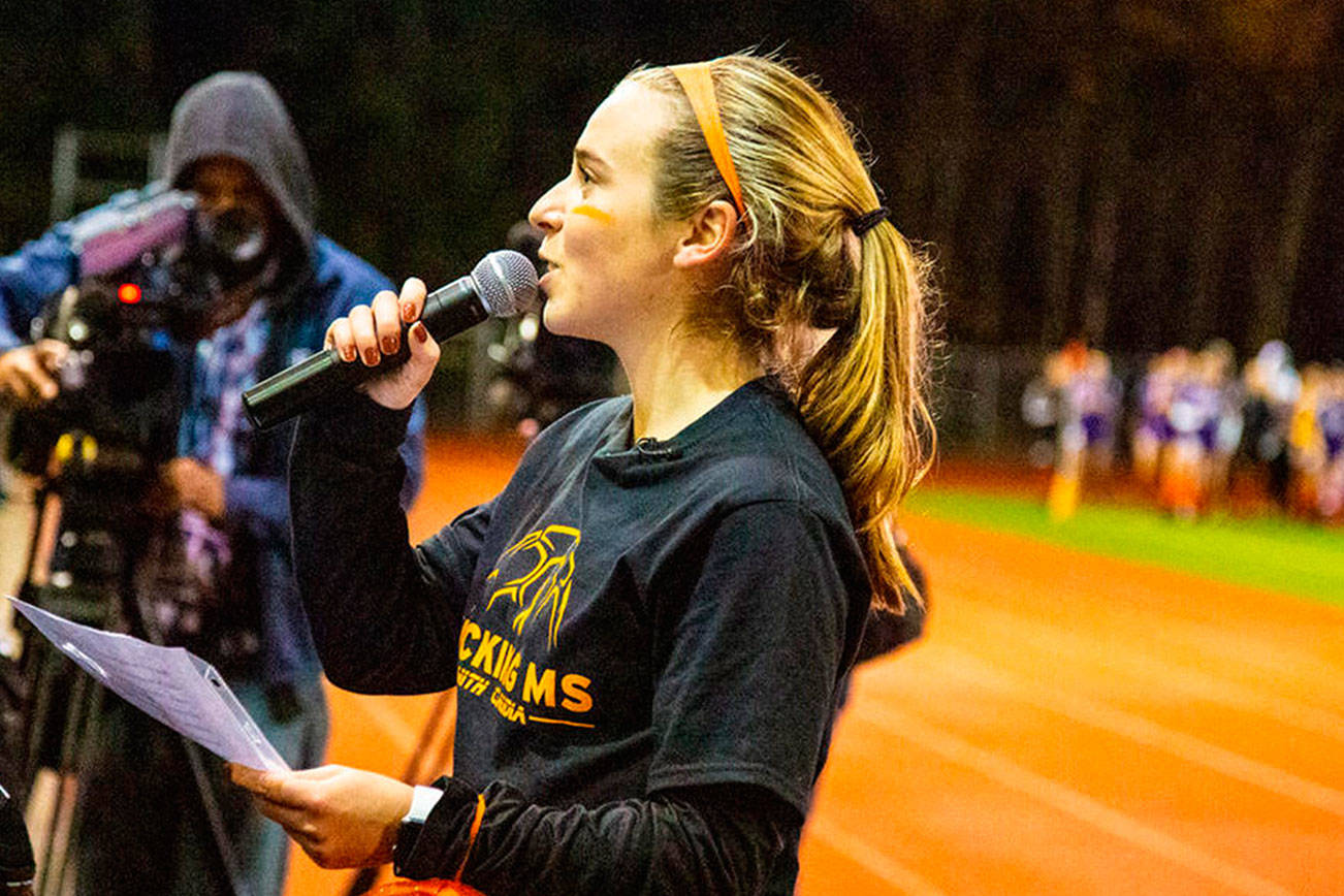 Issaquah Eagles 2018 graduate Claudia Longo addresses the crowd during halftime of the Issaquah Eagles/Lake Stevens Vikings playoff game. Photo courtesy of Don Borin/Stop Action Photography