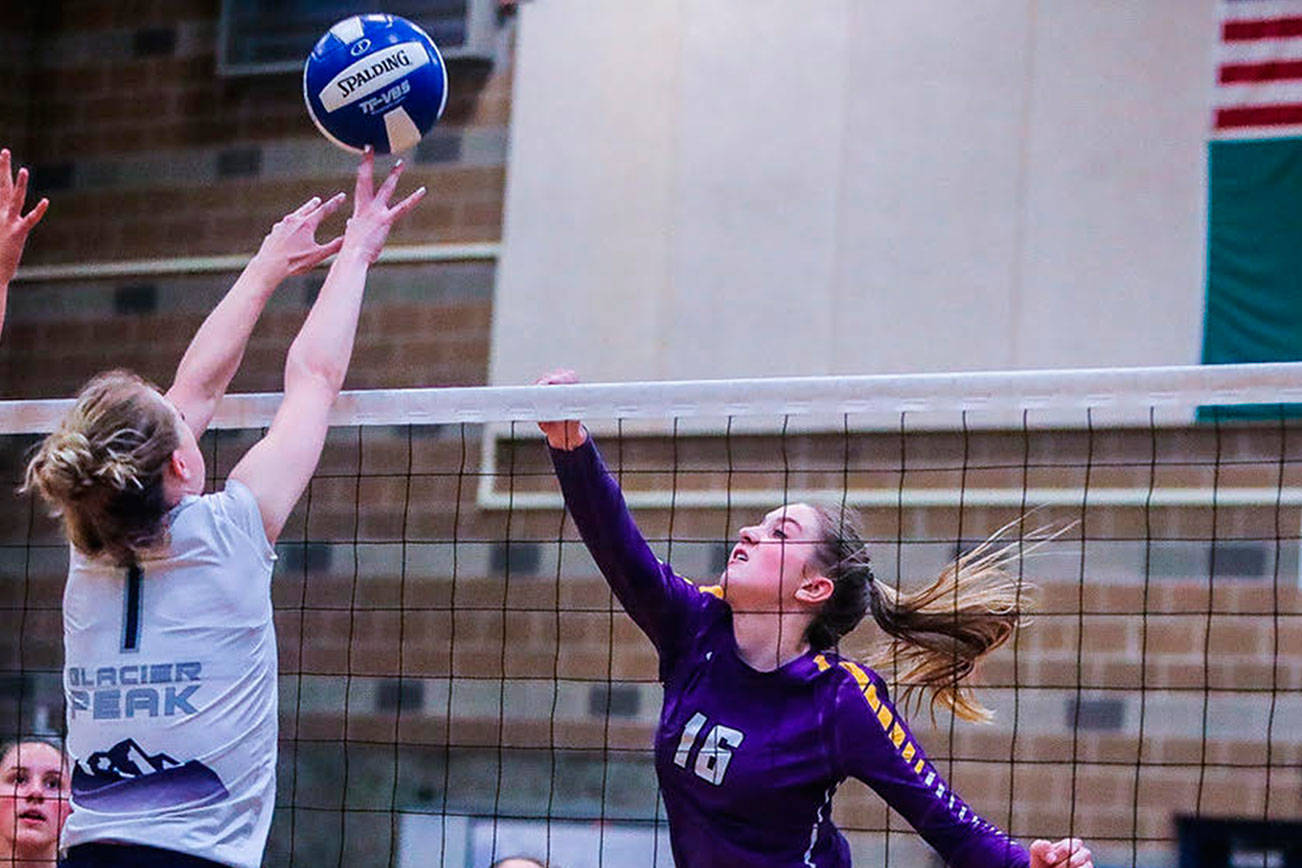 Issaquah senior outside hitter Liz Gorski (pictured) hits the ball over the net, keeping the play alive against Glacier Peak. Issaquah defeated Glacier Peak 3-0, clinching a berth in the Class 4A state volleyball tournament on Nov. 16-17 at the Yakima SunDome. Photo courtesy of Don Borin/Stop Action Photography