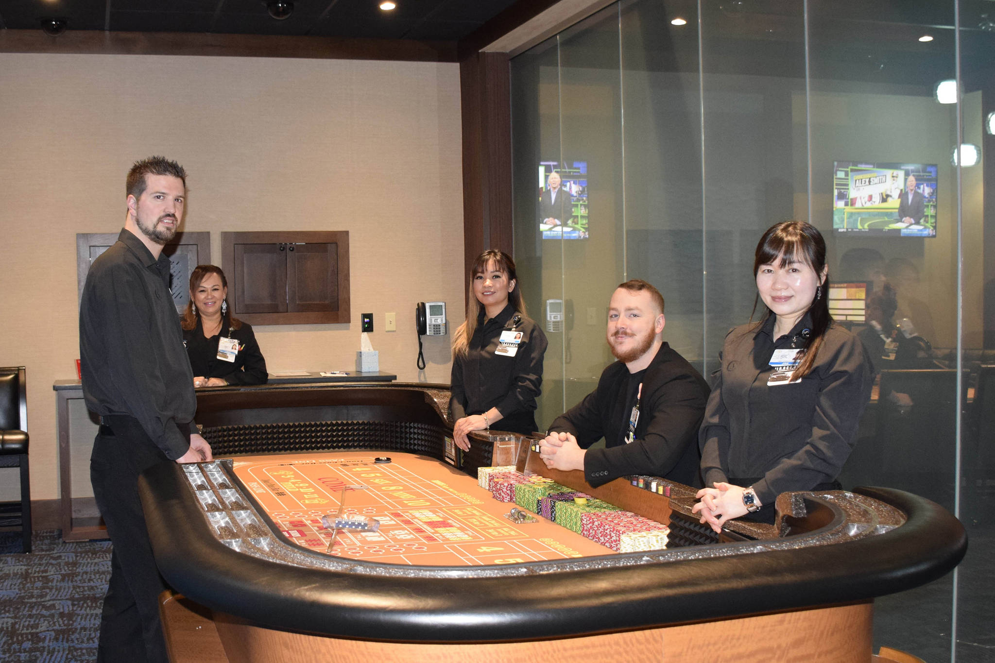 Snoqualmie Casino staff members surround a gaming table in the new private gaming room at Snoqualmie Casino. Photo courtesy of Tarah Smigun                                Snoqualmie Casino staff members (from left) Trevor House, Linda Yem, Sophorn Seng, Ross Garmon and Jan Wu surround a gaming table in the new private gaming room at Snoqualmie Casino. Photo courtesy of Tarah Smigun