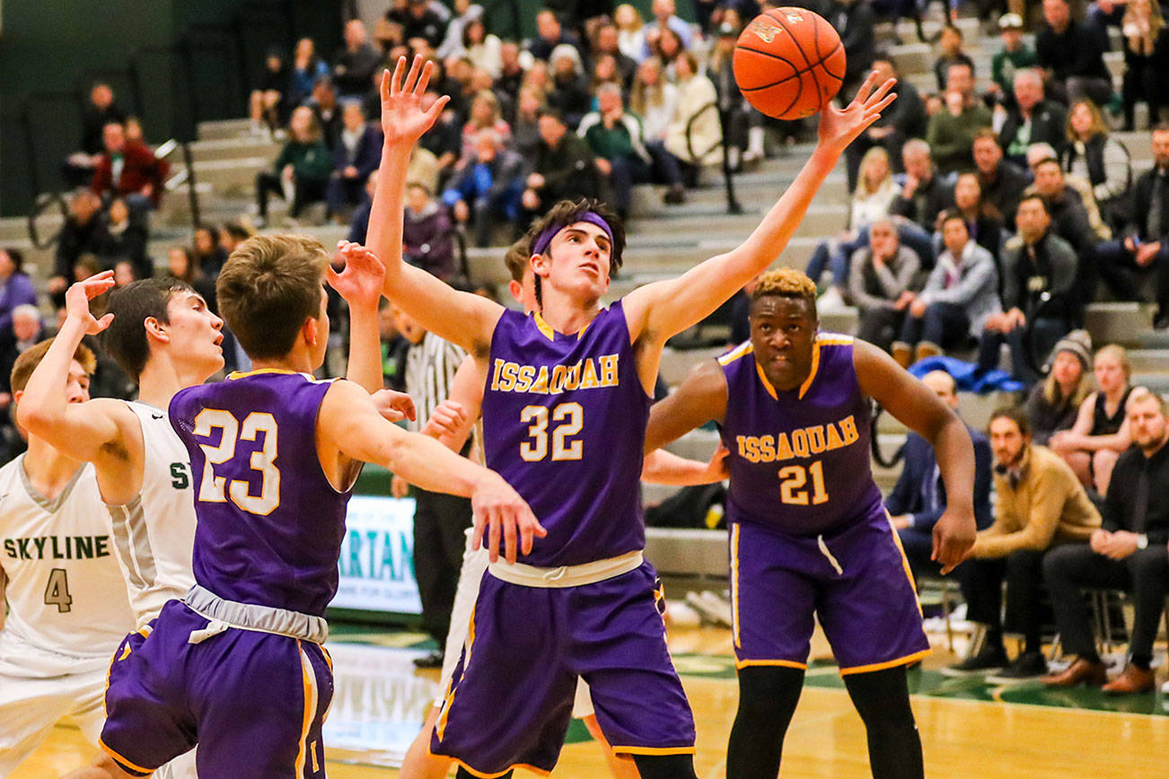 In showdown between rivals, the Issaquah Eagles boys basketball team rose to the occasion. Issaquah registered a 81-64 victory against the Skyline Spartans on Dec. 7. The Eagles improved their overall record to 2-3 with the victory. Issaquah sophomore Charlie Dietiker, center, corrals a rebound against the Spartans in the win. Photo courtesy of Rick Edelman/Rick Edelman Photography