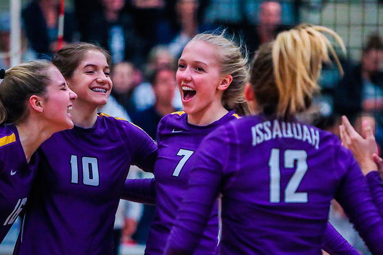 Issaquah Eagles volleyball player Sidney Cottrell (No. 7) celebrates with her teammates after they scored a point during the 2018 season. Cottrell, who was a junior during the 2018 season, earned Washington State Volleyball Coaches Association all-state, honorable mention honors for her play at the middle blocker position this past season. Photo courtesy of Don Borin/Stop Action Photography